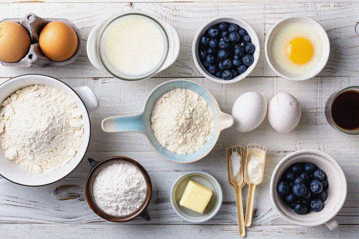 Organized ingredients for muffins recipe preparation displayed in flat lay composition